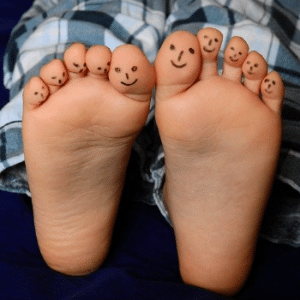 Childs feet with smiley faces